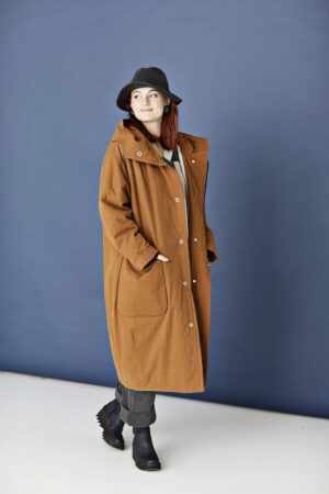 Terracotta coloured long and loose coat with a balloon silhouette and a hood